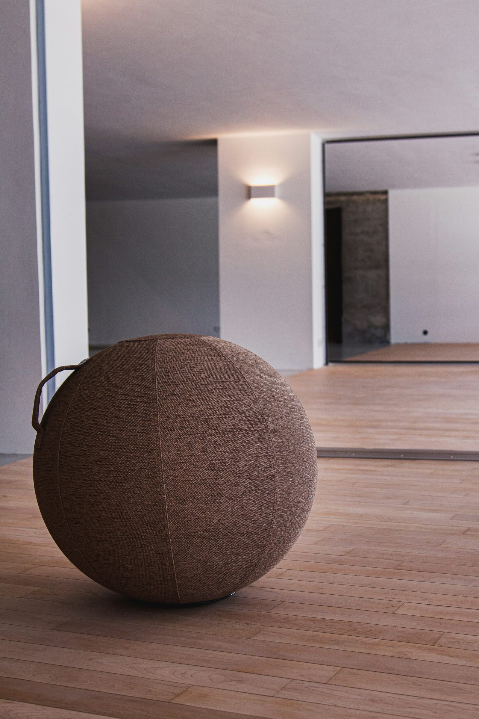 brown round cushion on brown wooden parquet floor